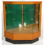 A retro mid century shop haberdashery corner counter cabinet. The oak body with plinth base having