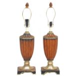A pair of 20th Century antique style faux wooden table lamps having urn shaped reeded bodies