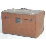 A vintage early 20th Century travelling trunk bound in brown canvas with painted initials WT and a