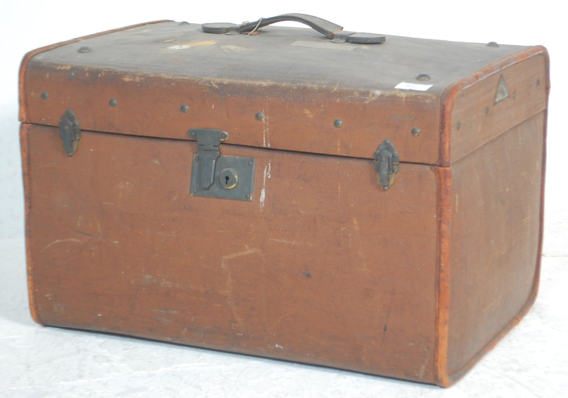 A vintage early 20th Century travelling trunk bound in brown canvas with painted initials WT and a