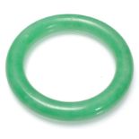 A Chinese Jade slave bangle of typical round form.