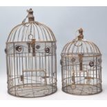 A pair of graduating 20th Century decorative bird cages having rope twist decoration and red stone