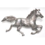 A stamped 925 silver brooch in the form of a galloping horse with a hinge pin to verso. Weight 7.2g.