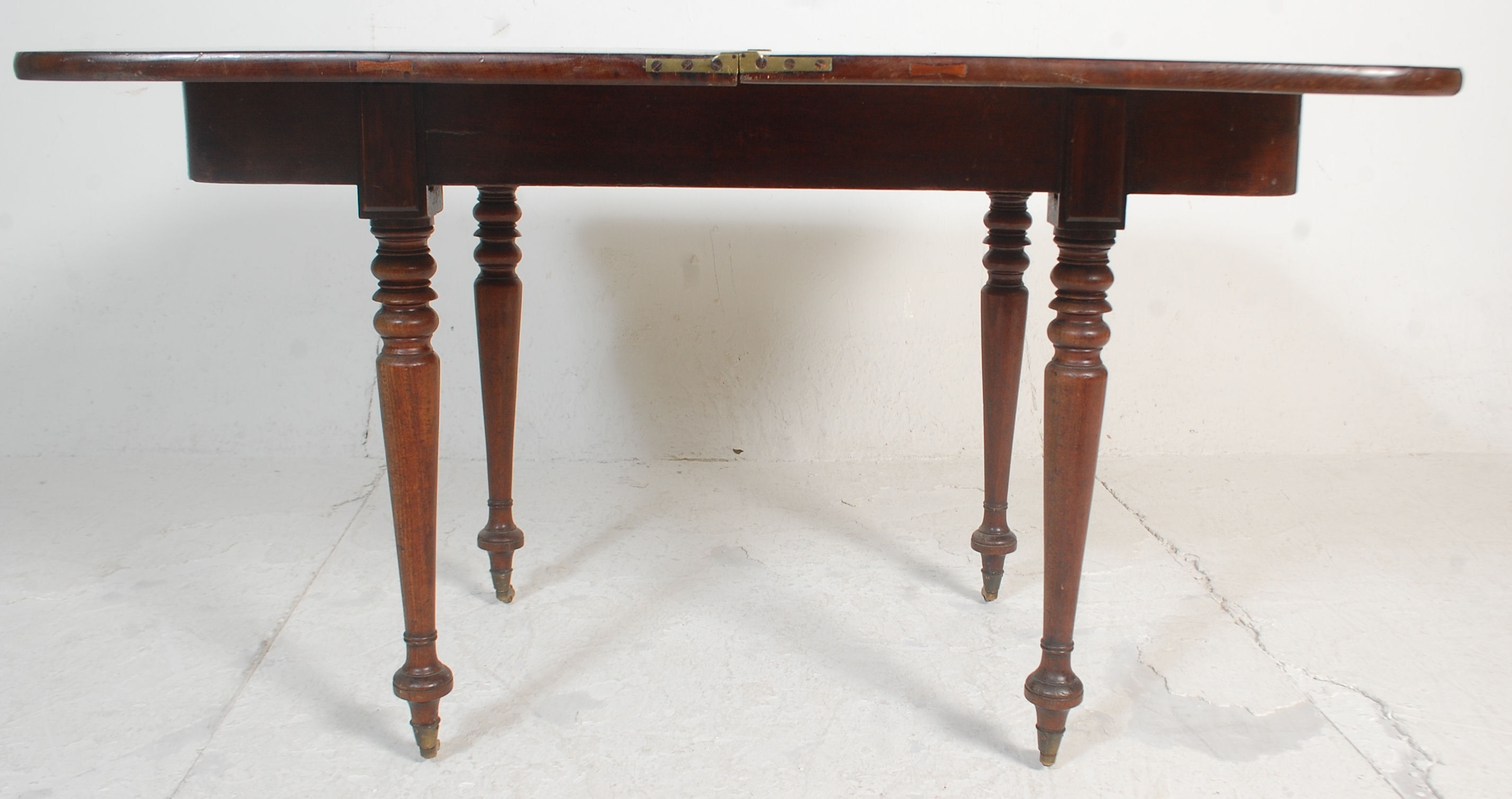 A 19th Century mahogany card / tea table having a folding and revolving top with brass fittings - Image 4 of 7