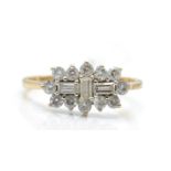 A hallmarked 9ct gold and white stone cluster ring. The ring set with baguette white stones
