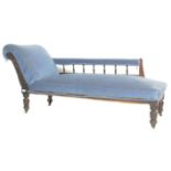 A late Victorian mahogany chaise longue daybed upholstered in blue velour fabric having spindle