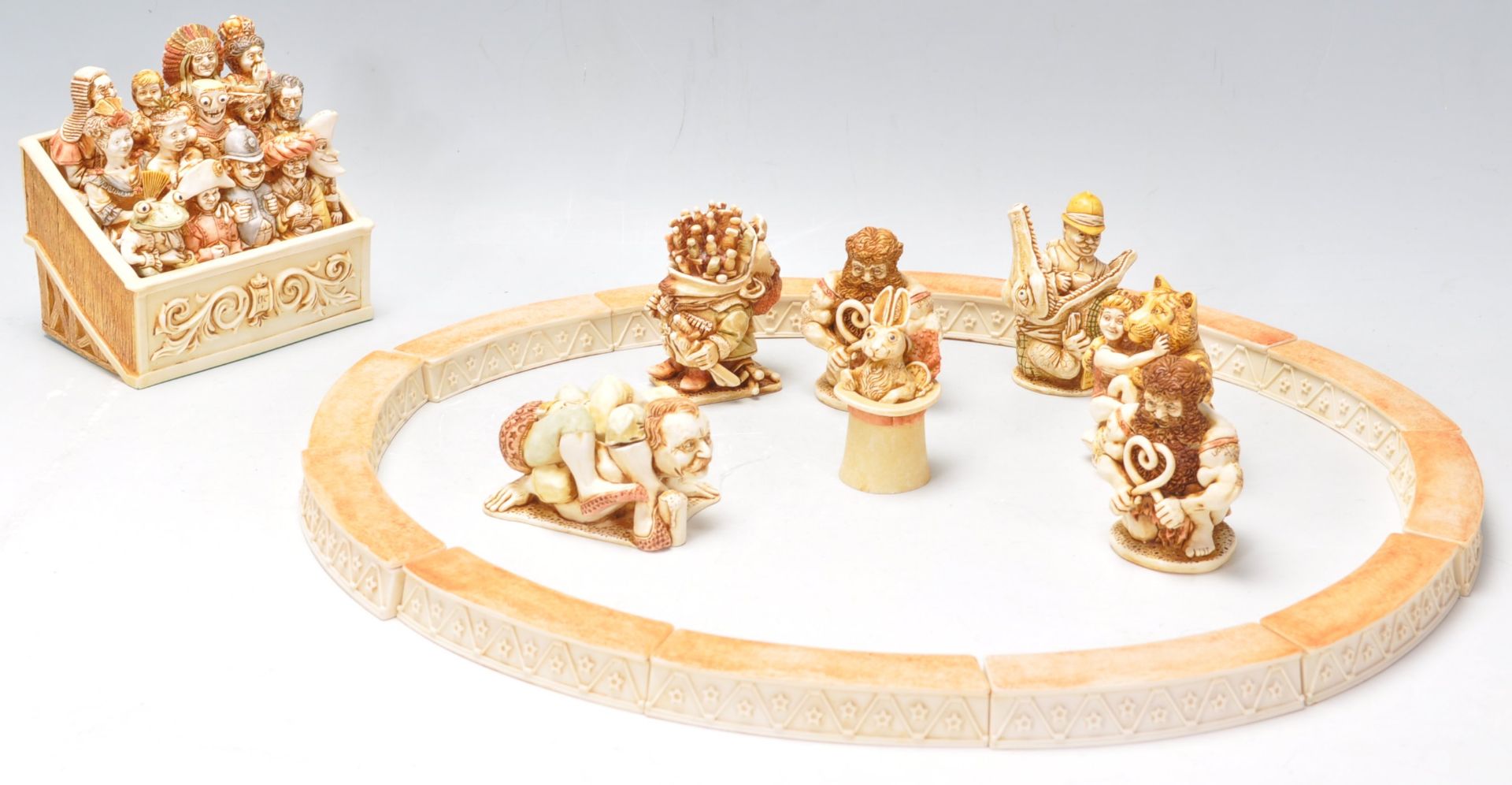 A group of Harmony Kingdom resin figurines in the form of a circus ring with spectators and