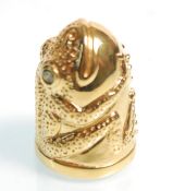 A gold plated thimble in the form of a frog having