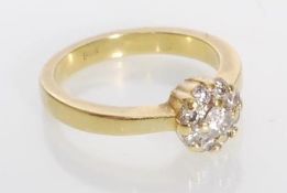 A stamped 18ct gold diamond cluster ring having a