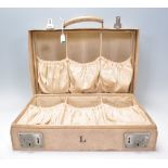 An early 20th Century white leather travel vanity
