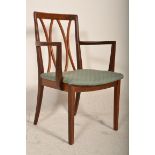 A 20th Century carver arm chair having a teak wood