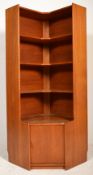 A mid century teak wood corner cabinet in the mann