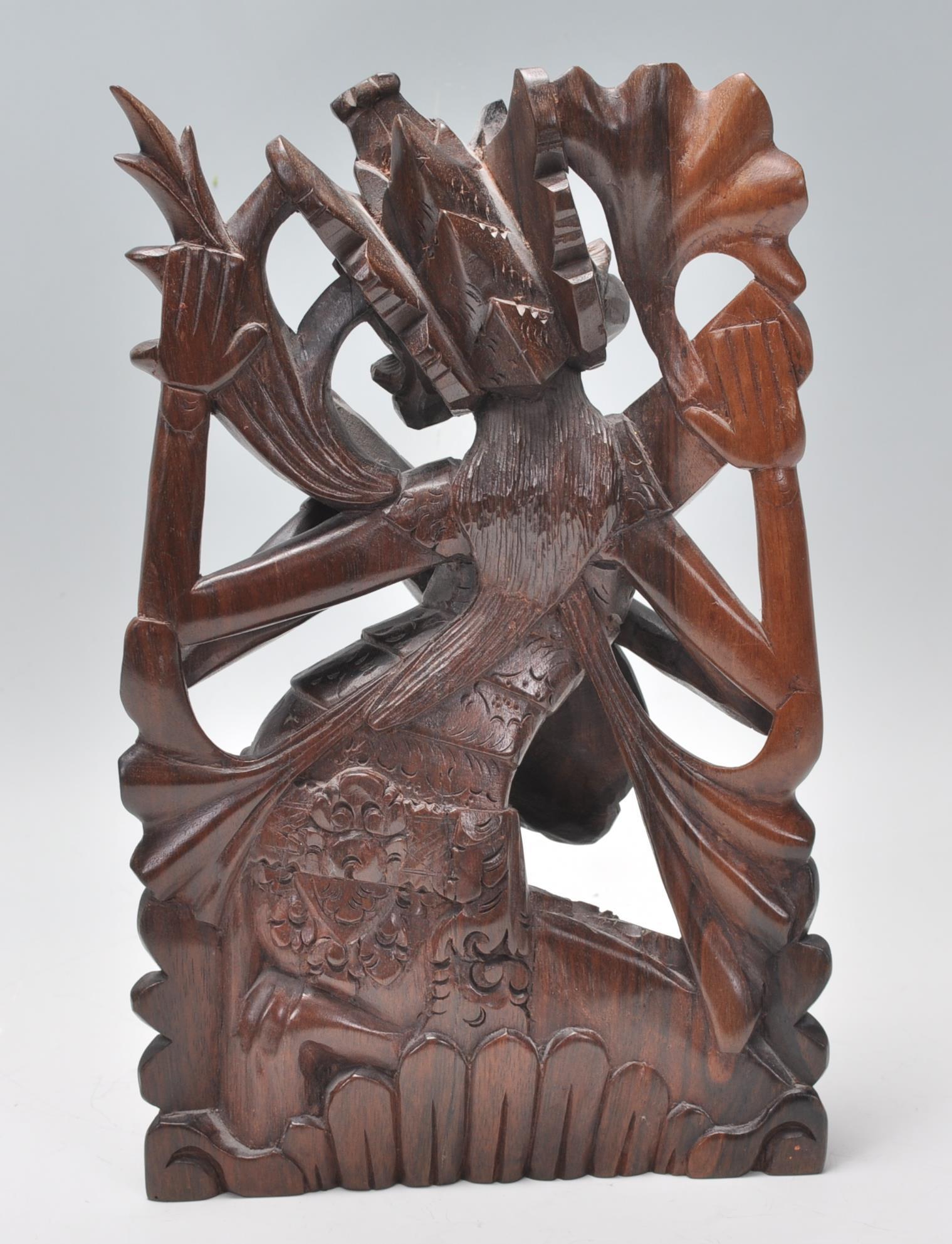 A 20th Century carved dark wood figurine of a Hind - Image 3 of 7
