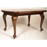 An Edwardian solid mahogany extending dining table