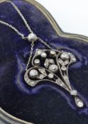An Art Nouveau diamond pendant necklace. The necklace strung with a pierced diamond