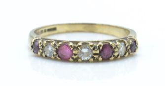 A hallmarked London 9ct gold ruby and diamond 7 stone ring. Total weight 1.4g / Size K.5
