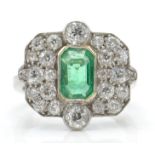 An 18ct white gold emerald and diamond ring.