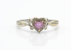 A hallmarked 9ct white gold pink stone and diamond ring. The ring having a central heart cut pink