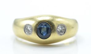 A 14ct / 585 gold sapphire and diamond dome ring. The ring set with a central oval mixed cut sapphir