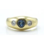 A 14ct / 585 gold sapphire and diamond dome ring. The ring set with a central oval mixed cut sapphir