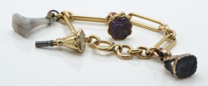An 18ct gold charm bracelet. The 18ct stretch link bracelet set with a 14ct gold intaglio