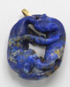 A gold and Lapis Lazuli figural pendant. The pendant depicting 2 carved entwined panthers having gol