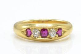 An 18ct gold ruby and diamond ring. The ring set with 3 graduated oval cut rubies