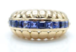 14ct gold and sapphire dome ring. The ring set with a central panel of square cut sapphires
