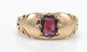An Edwardian Chester hallmarked 9ct gold band ring set with a mixed cut garnet