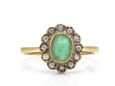 A hallmarked 9ct emerald and diamond cluster ring