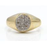 A hallmarked 9ct gold and diamond ring. The ring having a central oval plaque set