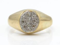 A hallmarked 9ct gold and diamond ring. The ring having a central oval plaque set