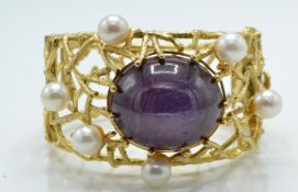 A large 18ct gold ruby and pearl wirework bracelet - bangle.