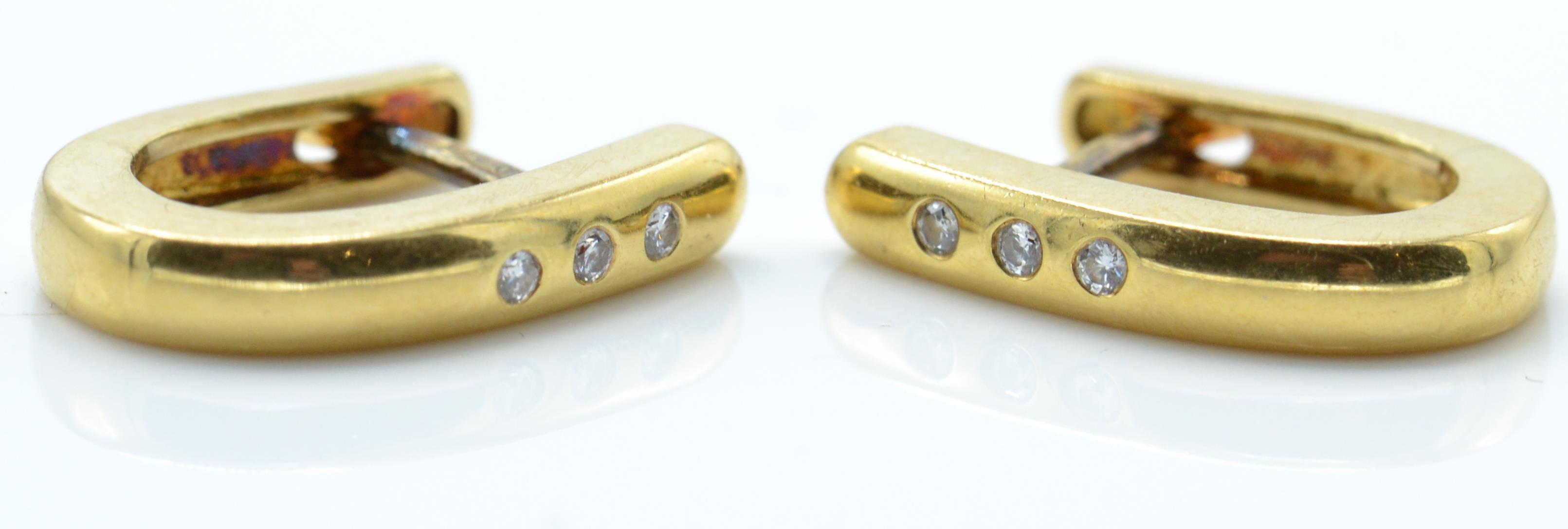 A pair of hallmarked 18ct gold and diamond earrings.