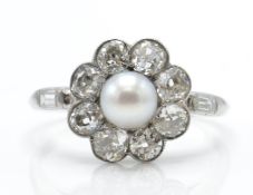 A platinum diamond and pearl cluster ring. Estimated diamond weight 1.5cts