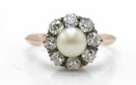 A 14ct gold pearl and diamond cluster ring. Estimated diamond weight 0.80cts