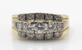 A 14ct / 585 gold and diamond cluster ring. The ring set with a central band of graduated diamonds