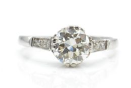 A platinum and diamond solitaire ring. The ring set with a central round brilliant cut diamond