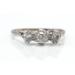 An 18ct white and platinum 3 stone ring. The ring set with graduating old cut diamonds