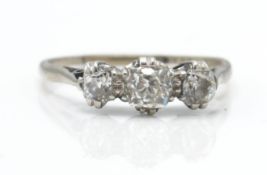 An 18ct white and platinum 3 stone ring. The ring set with graduating old cut diamonds