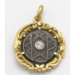 A 19th century gold and diamond pendant. The pendant having a gold scrolled foliate mount