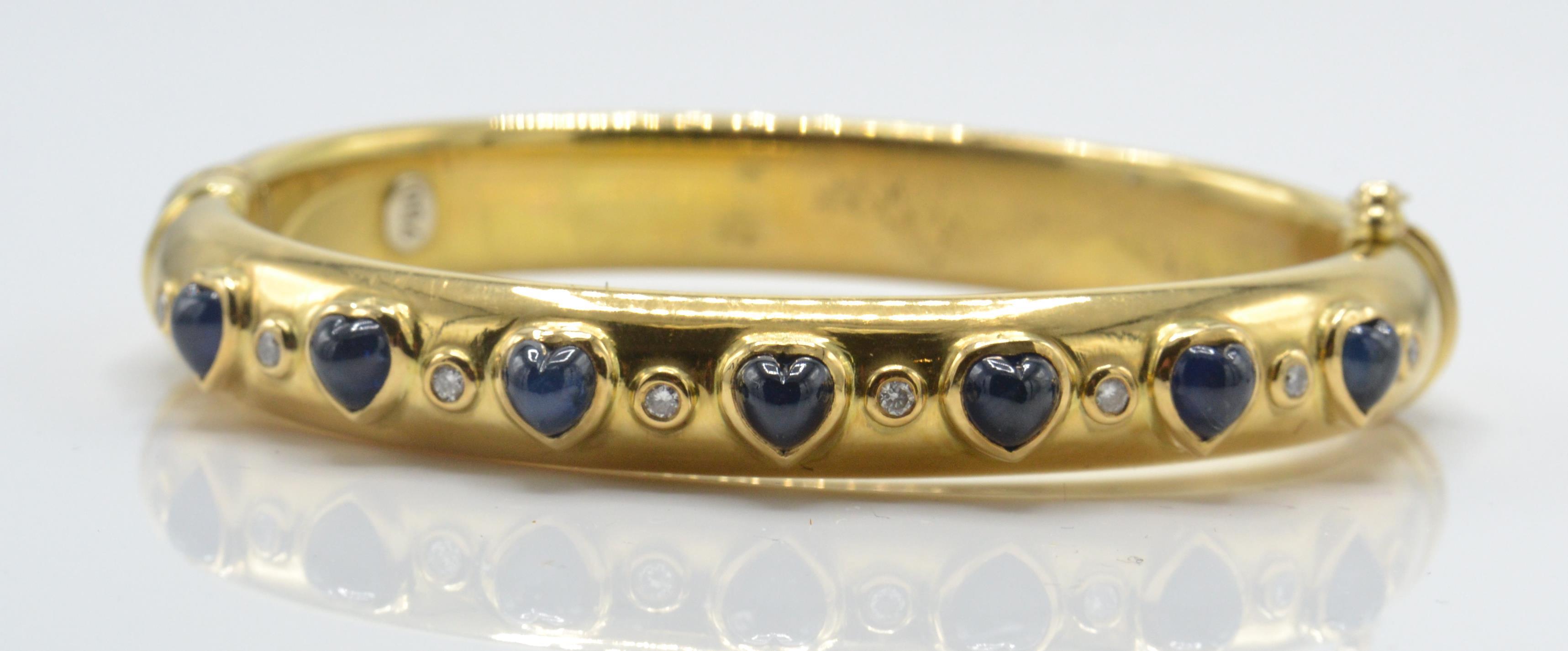 An 18ct gold sapphire and diamond bangle. The bangle set with heart shaped sapphire cabochons - Image 2 of 5