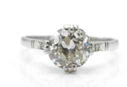 An 18ct white gold and diamond ring. The ring having a central round brilliant cut diamond