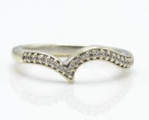 A hallmarked 9ct white gold and diamond wishbone ring.