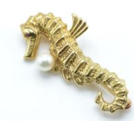 A 20th centurty14ct gold figural brooch in the form of a seahorse with central pearl.