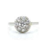 A platinum and diamond cluster ring. The ring having a central diamond of approx 0.25ct surrounded