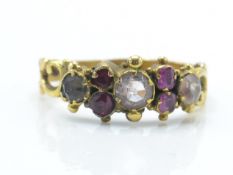 An antique gold ruby and coloured stone ring. The ring being set with ruby, white and red and pink