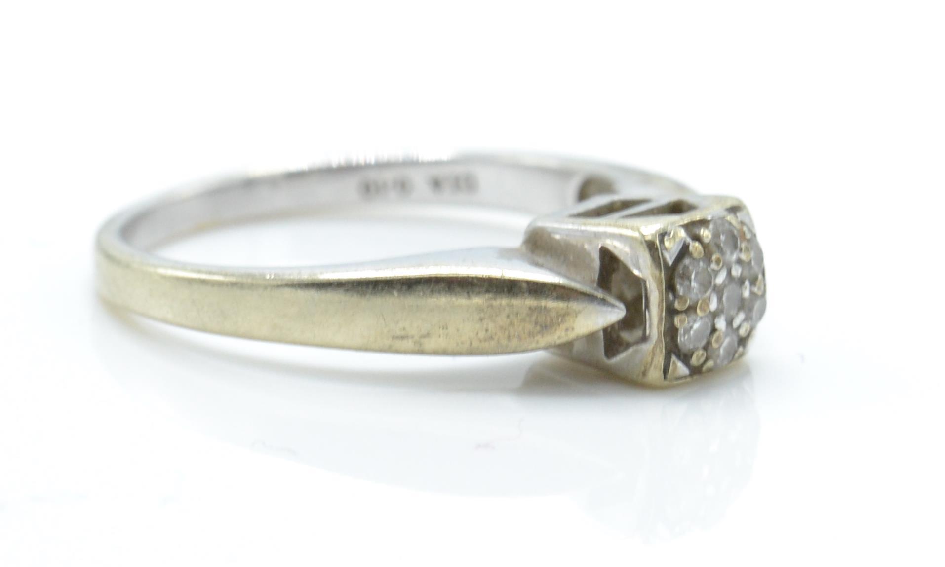 A hallmarked 9ct white gold and diamond ring. The ring having a cluster of diamonds within a - Image 3 of 5