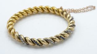 A French 18ct gold sapphire and diamond bangle / bracelet.