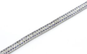 An 18t gold sapphire and diamond bracelet. Estimated diamond weight 2.8cts